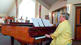 student Charlotte playing a grande piano