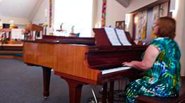 student Sherry playing a grande piano